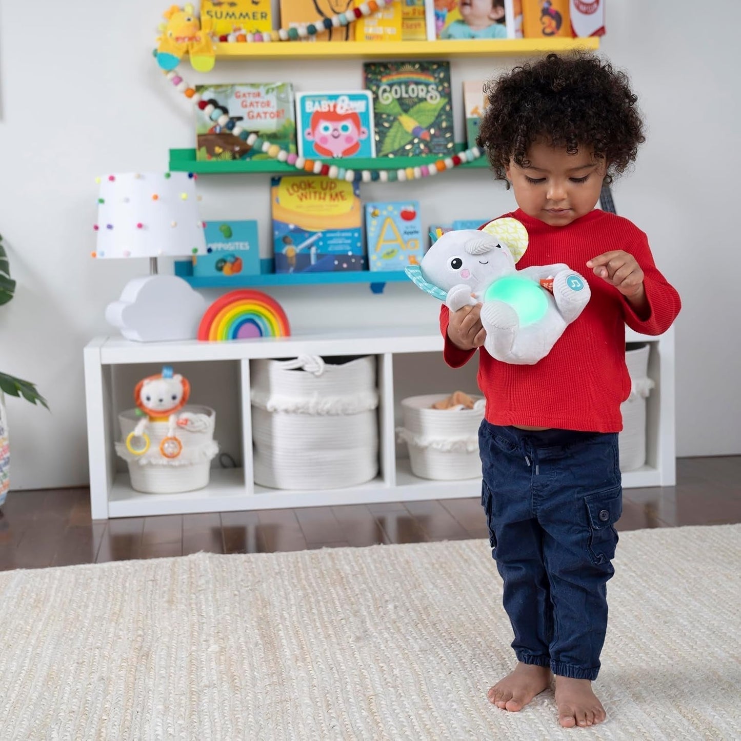 Bright Starts, Elefantino Hug-a-bye con luci, canzoni, texture diverse e altro, multicolore Toys Bebe Naty Shop