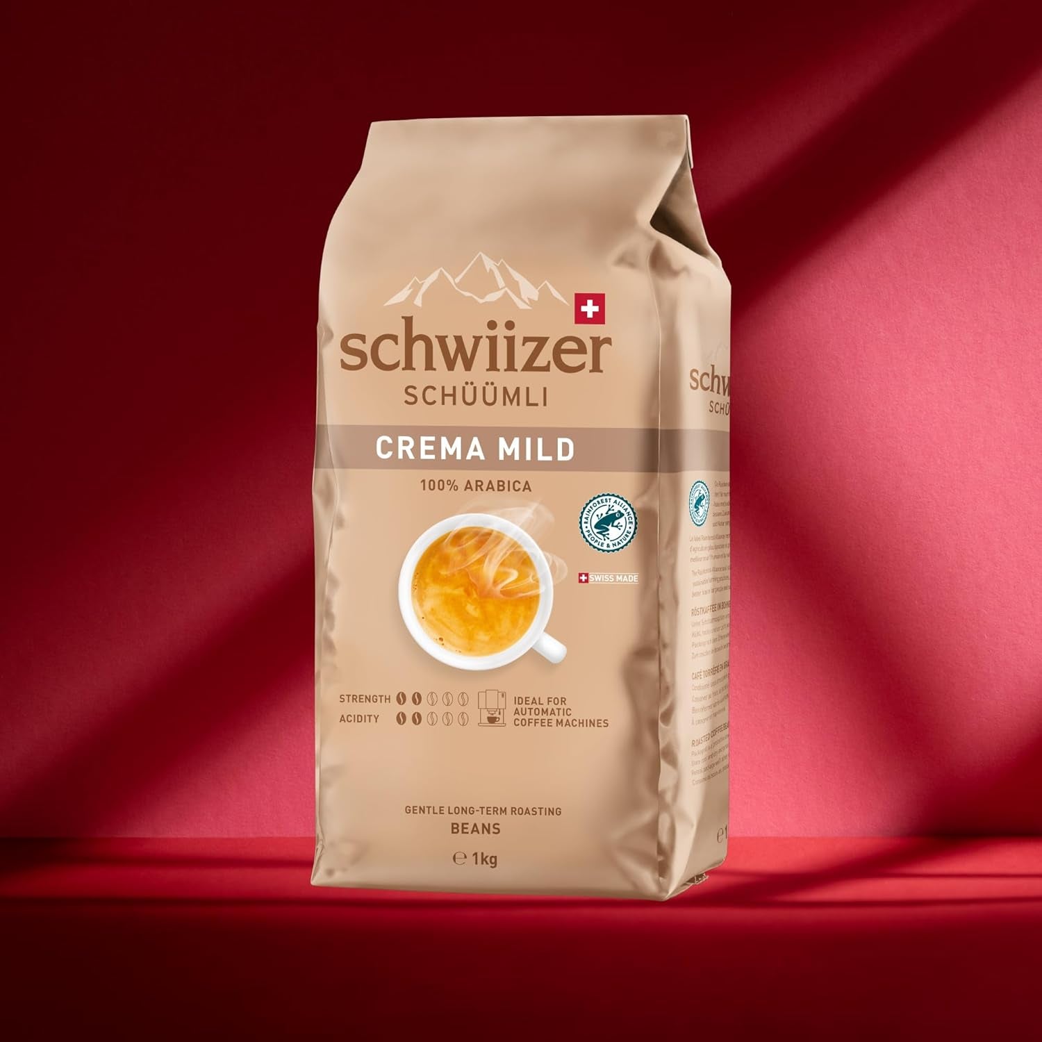 Schwiizer Schüümli Crema Mild, chicchi di caffè 100% Arabica fini, armoniosi e delicati, ideale per macchine espresso automatiche, forza 2/5, tostatura chiara, Rainforest Alliance, 1kg