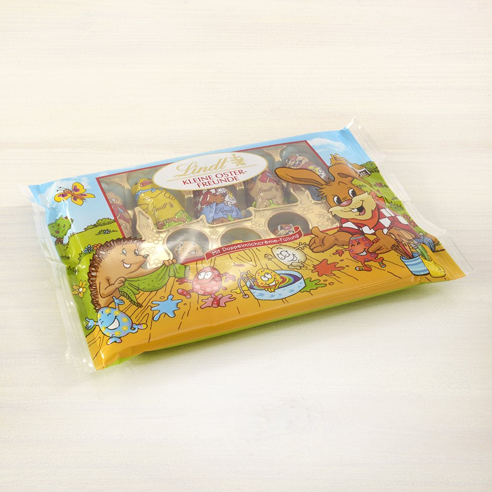 Piccoli Amici di Pasqua al Cioccolato | 2 x 100 g e Mini Uova Decorazione di Cioccolato con Latte Alpino | 2 bustine da 180 g | Uova di cioccolato al latte premium, confezionate in modo allegro e colorato, in quattro colori per Pasqua