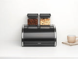 Brabantia portapane per rotoli - Contenitore compatto da banco per pane, bagel e panini con coperchio piatto, acciaio resistente - misura media - nero opaco Contenitori per alimenti Naty Shop